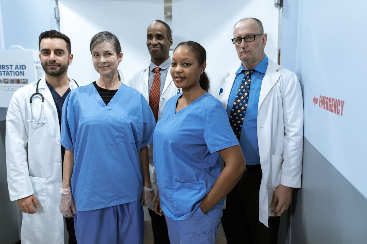 A diverse group of healthcare professionals in hospital uniforms, showcasing teamwork and diversity.
